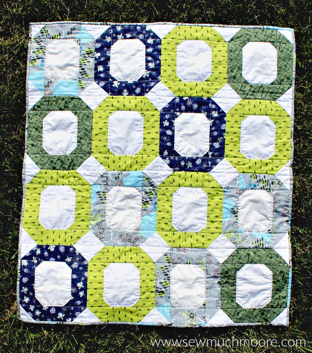 This baby quilt is super fun and easy to make! This modern quilt is perfect for a quick gift. #ForBeginners #easy #jellyroll #ideas #modern #baby #ToMake #Designs #Simple #Blocks #Tutorial #HandQuilting #Big Stitches #Embroidery #quilting #sewing #handmade #GiftForBaby #FreeMotionQuilting #Project #Patchwork #Contemporary #WalkingFoot #DIY #Fabric #BabyBoy #BabyGirl #Nursery #Bedding #SewMuchMoore #SewMuchMooreInStore #Hip #Trendy