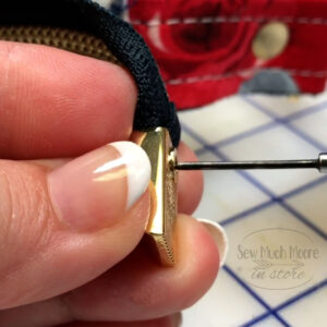 Installing the screw for the zipper end