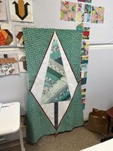 Cindy is finishing her wall tree. 